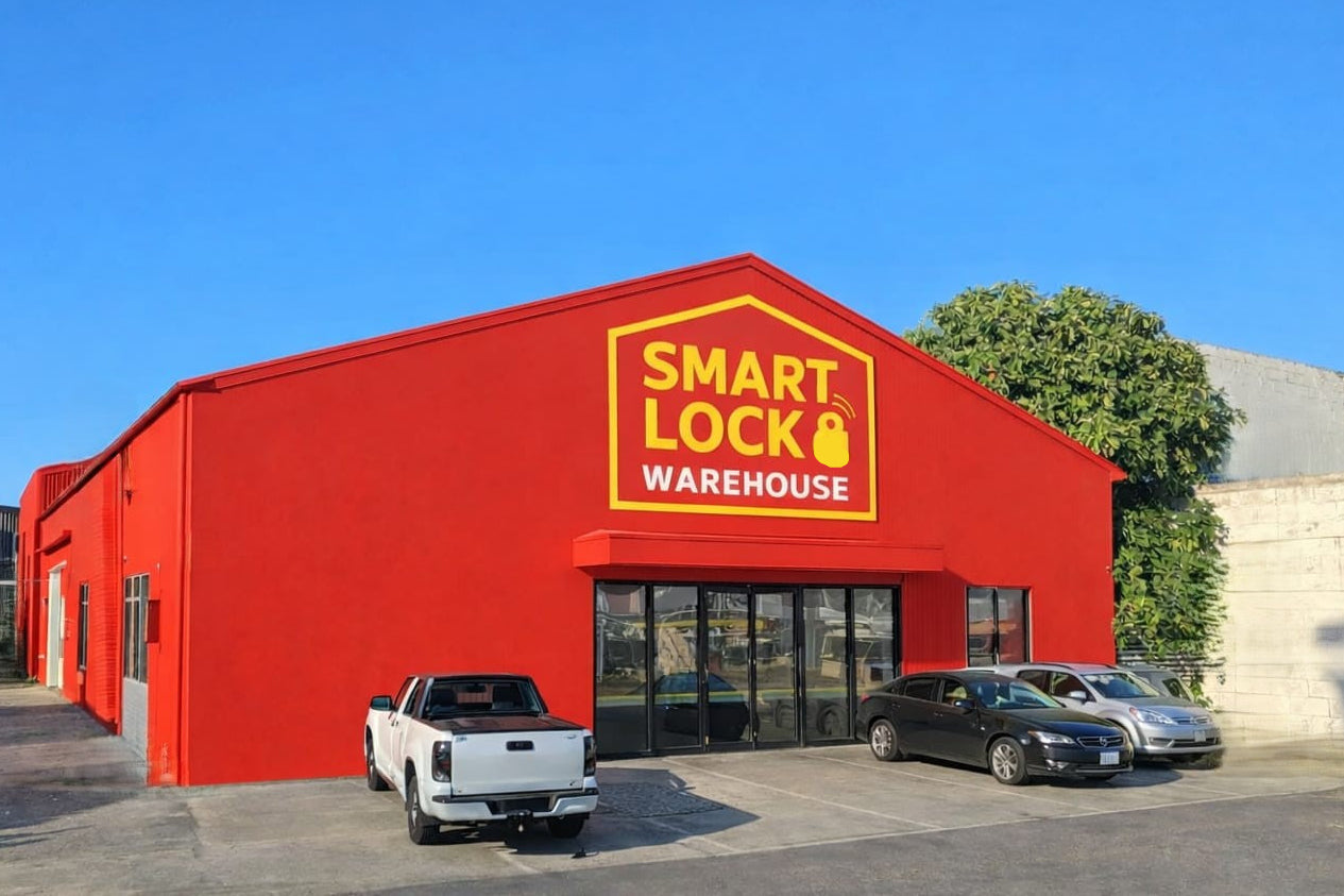 Red warehouse building with 'Smart Lock Warehouse' sign, cars parked in front