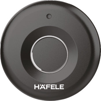 Black circular object with 'HAFELE' branding on a white background